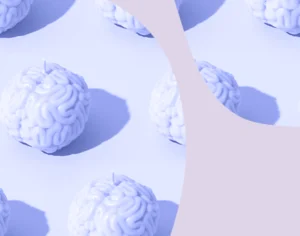 Grafika, na jasnym tle małe plastikowe świeczki w kształcie mózgu z fioletowymi elementami graficznymi. Medicante